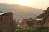 Sunset view over the rugged hills of Sumba with traditional houses in the foreground