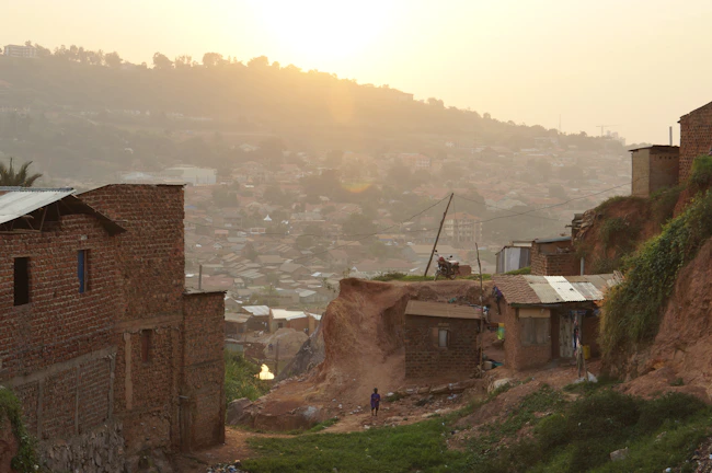 Sunset view over the rugged hills of Sumba with traditional houses in the foreground