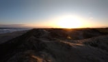 Sunset view over smooth sand dunes evoking calm and quiet renewal.