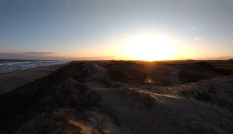 Balcony view overlooking the serene dunes of Nida at sunset.