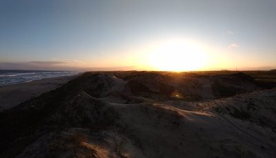 Sunset view over smooth sand dunes evoking calm and quiet renewal.