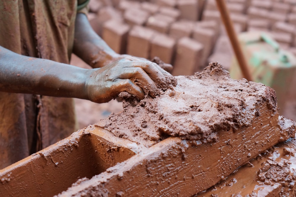 person holding clay