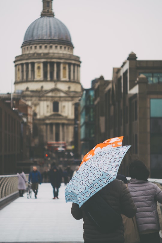 group of people holding umbrellas towards a cathedral in St. Paul's Cathedral United Kingdom