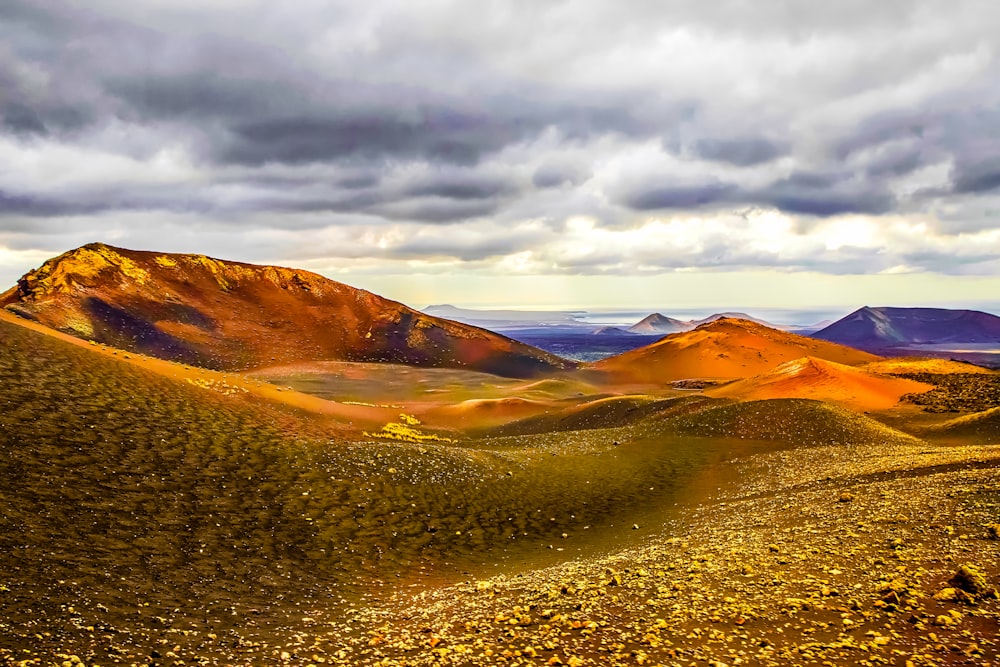 grass and soil covered field and mountains