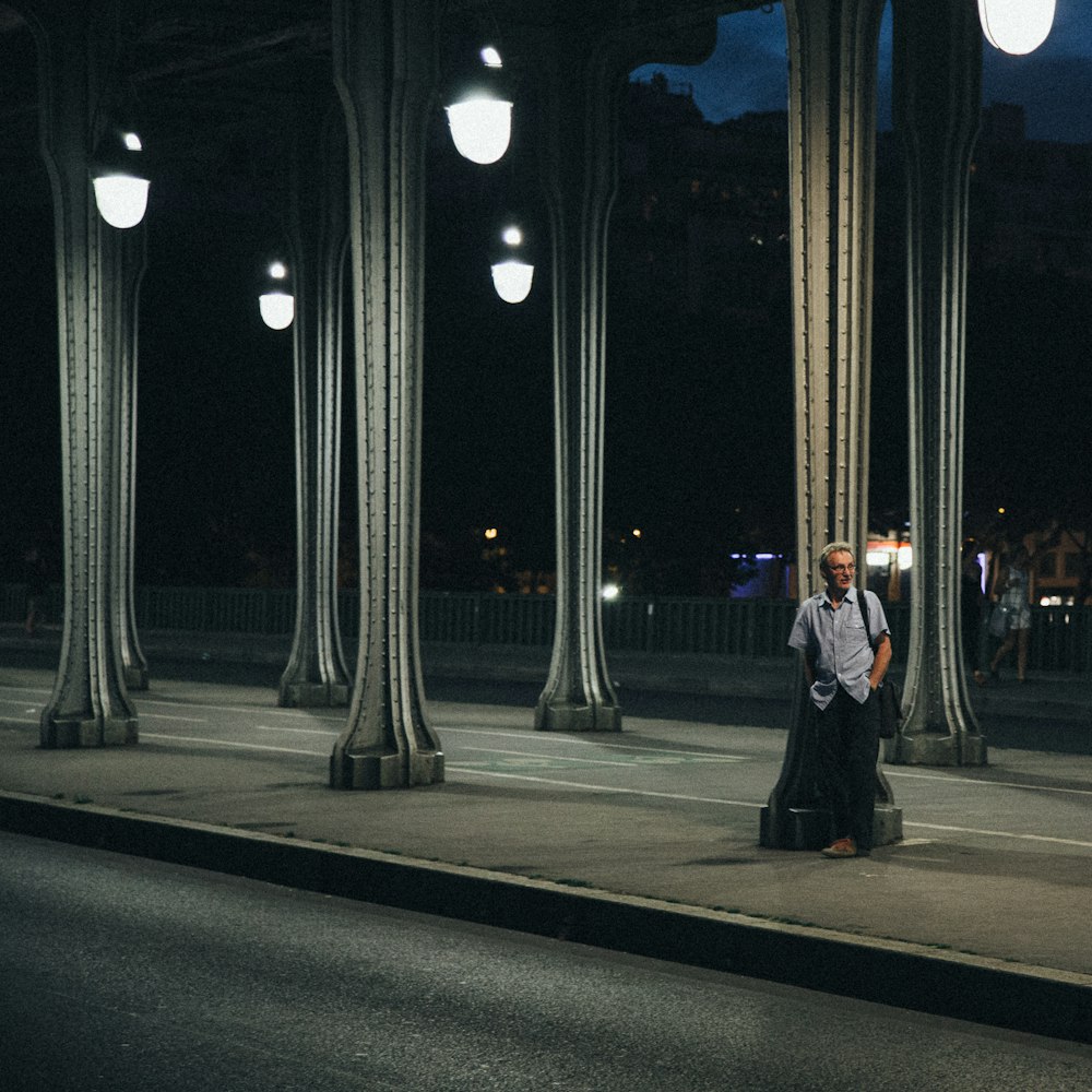 people walking on sidewalk during night time