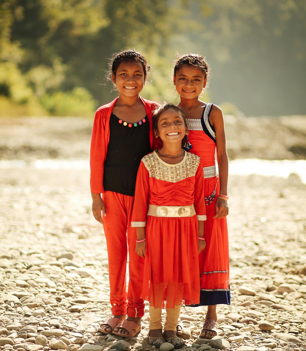 three toddler's in red clothes