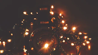 A softly lit studio scene with a vintage camera and warm fairy lights creating an inviting atmosphere.