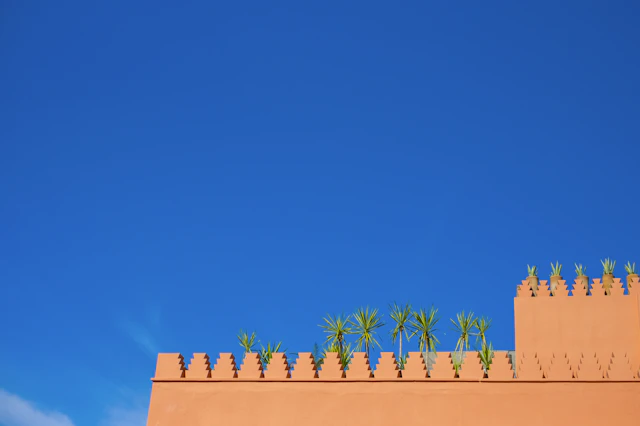 Red ochre ramparts of Marrakech under a blue sky