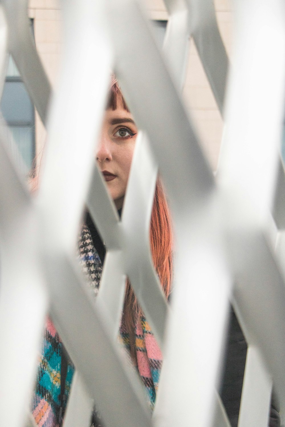 man peeping through white fence