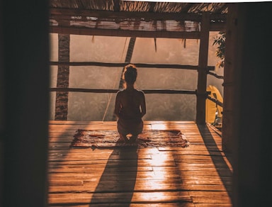 Solo meditation in Rishikesh with a woman sitting on the floor, embracing Himalayan serenity