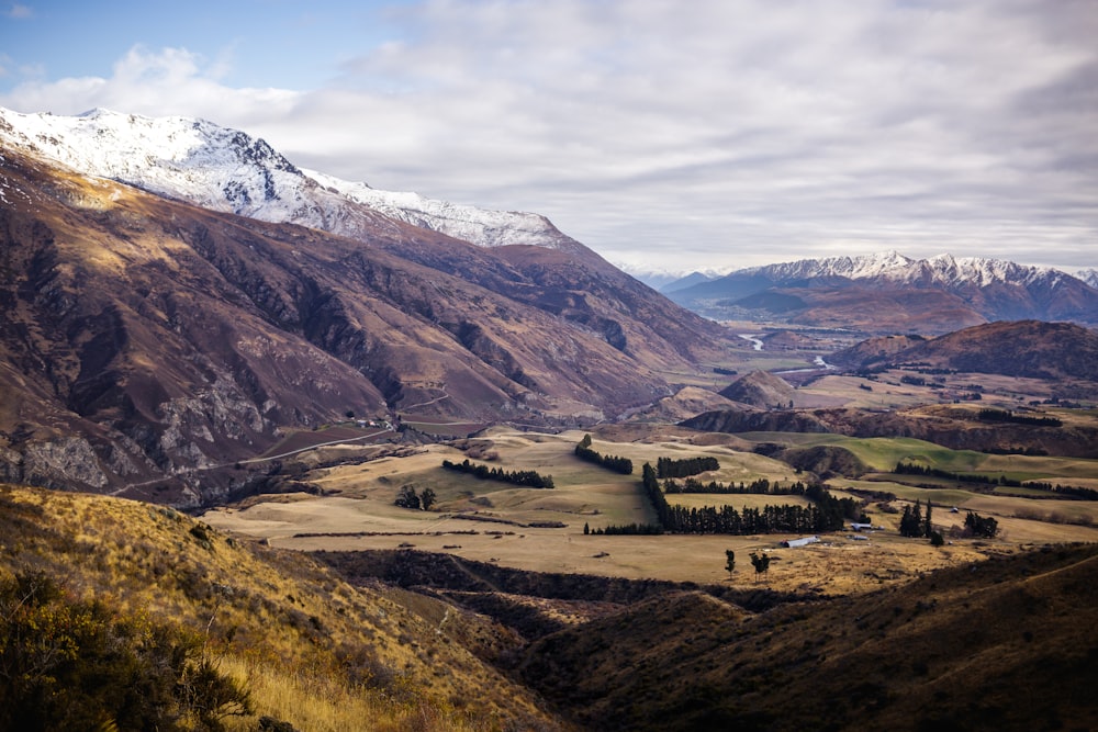 a view of a valley with mountains in the background