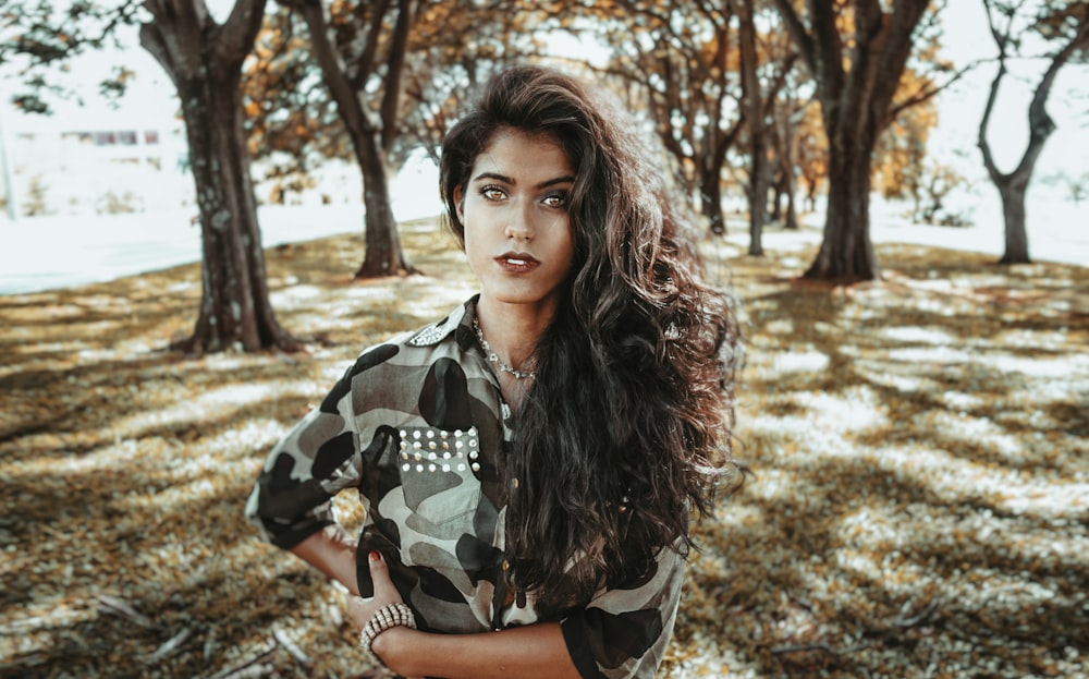 woman standing in front of trees during daytime