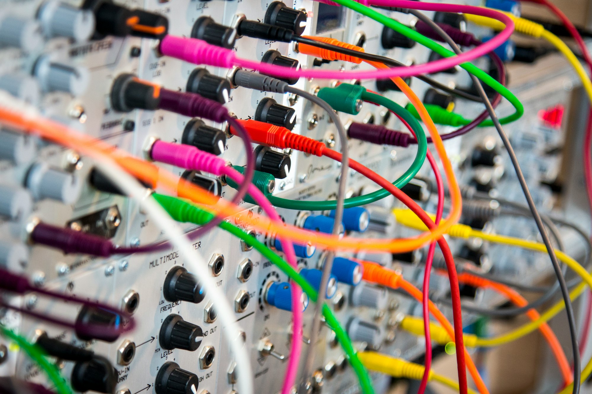 A series of brightly-colored cables connect many machines.