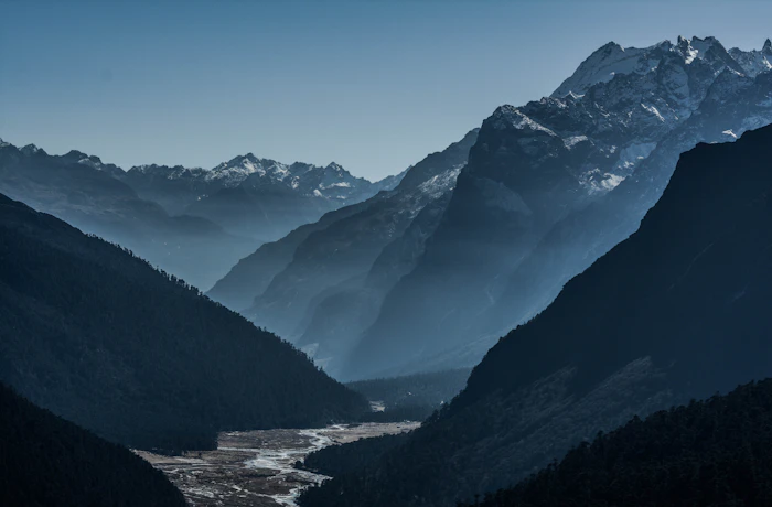 A river winding through a misty Sikkim mountain valley