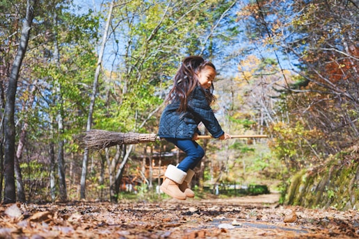 girl riding broom stick