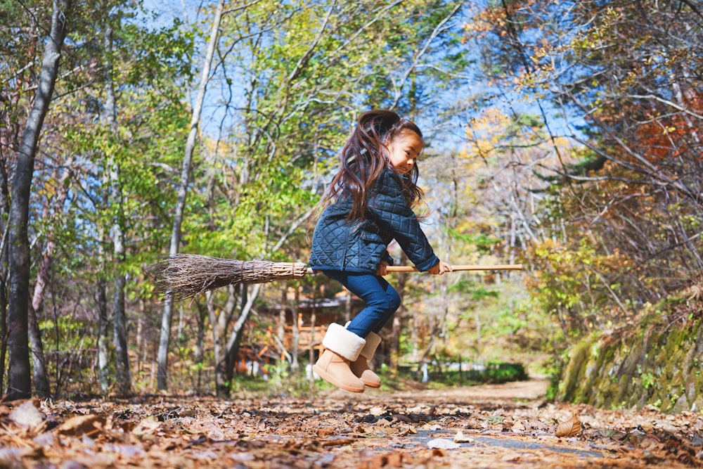 girl riding broom stick