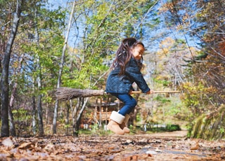 girl riding broom stick