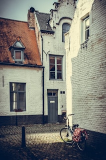 A quiet European alleyway bathed in warm afternoon light, shadows playing on cobblestones