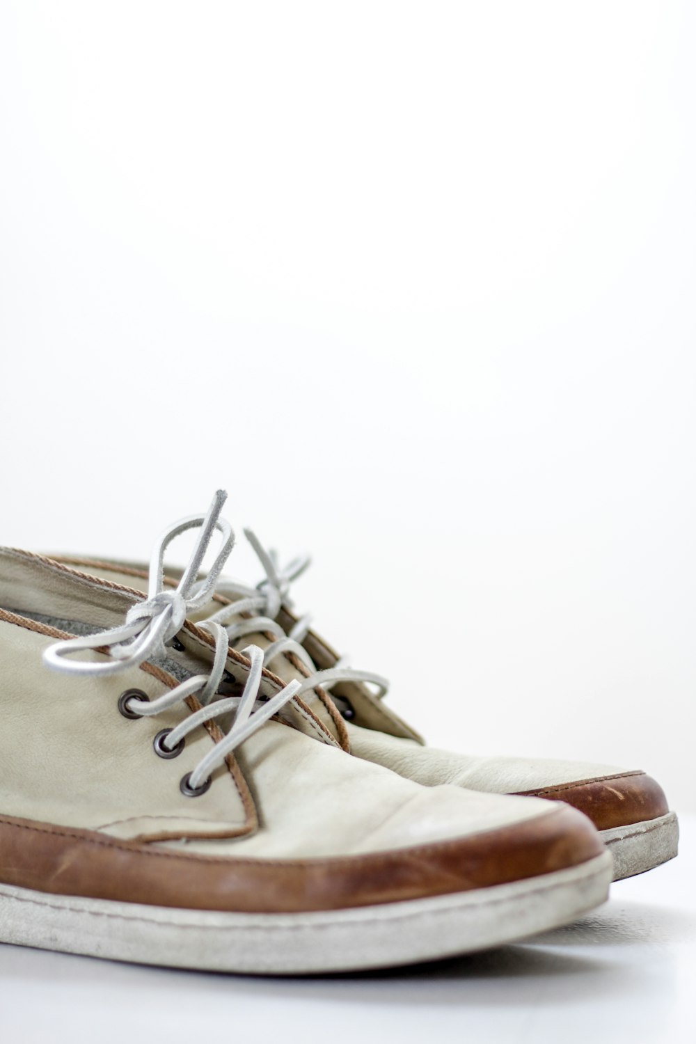 pair of beige chukka boots