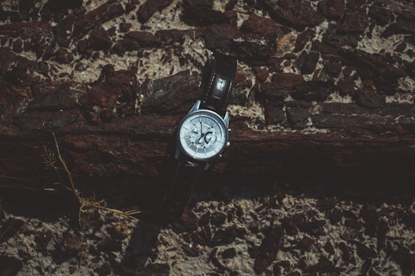 Side view of an Infantry Co watch featuring a stainless steel case and a durable nylon strap resting on a wooden surface