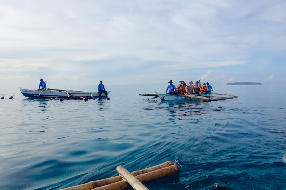 boats with people under white sky