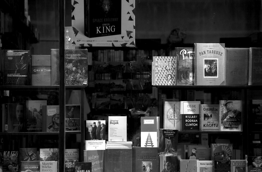 grayscale photo of assorted books