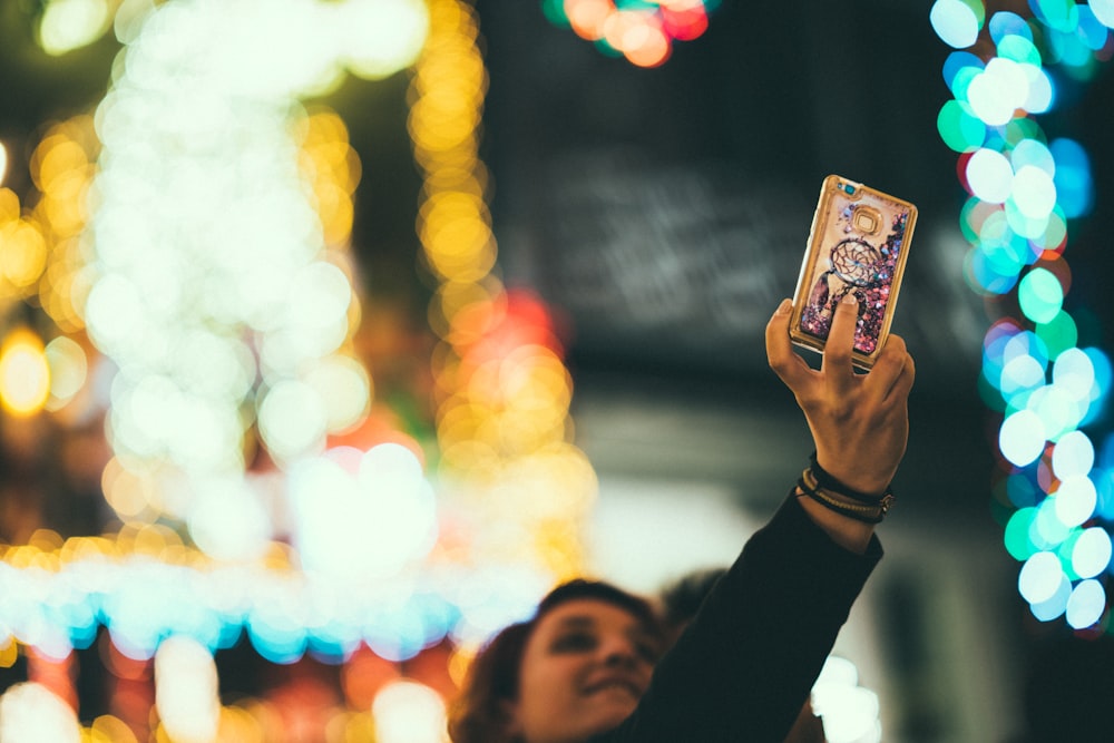 girl holding smartphone taking selfie