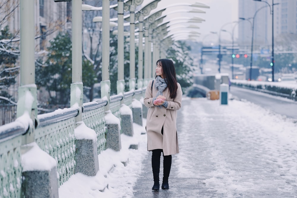 woman standing on bridge during daytime