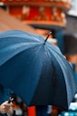 great in storm person holding umbrella while raining