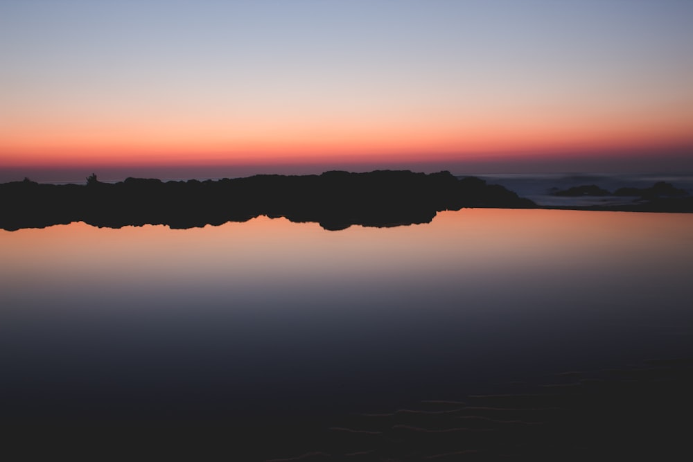 landscape photography of body of water near island