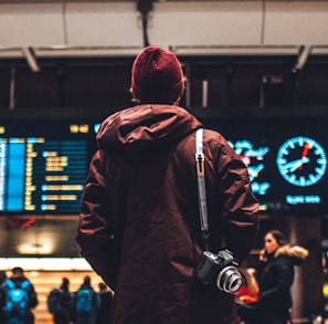 person looking up to the flight schedules