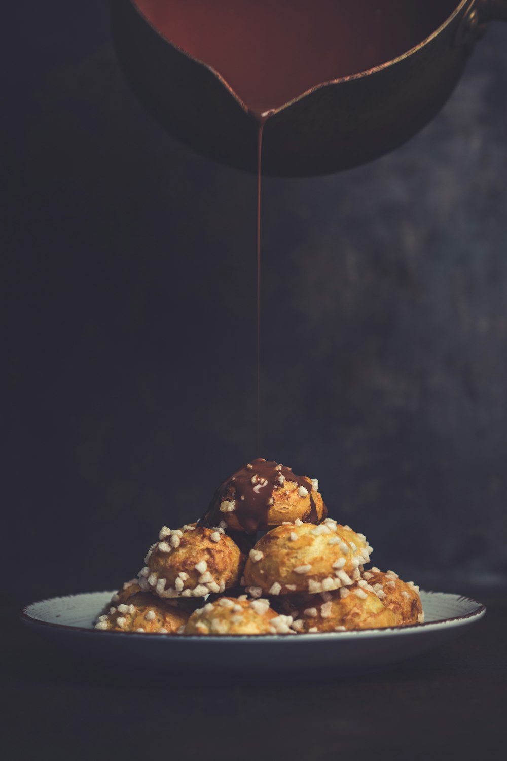 pouring chocolate on baked pastries