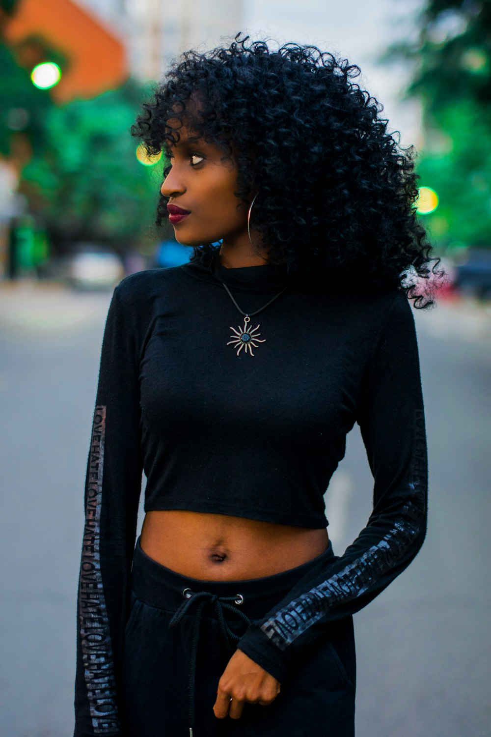 close-up photography of woman standing on the street during daytime