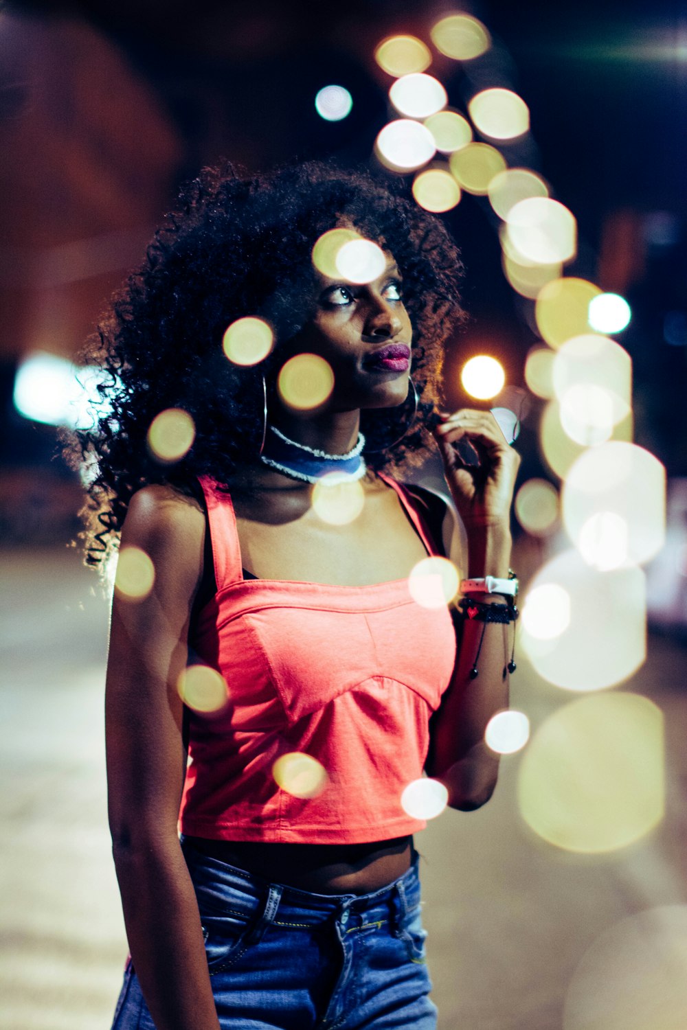 woman wearing red crop top standing near building