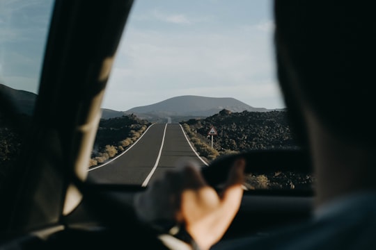 person driving a vehicle in the middle of the road in Lanzarote Spain