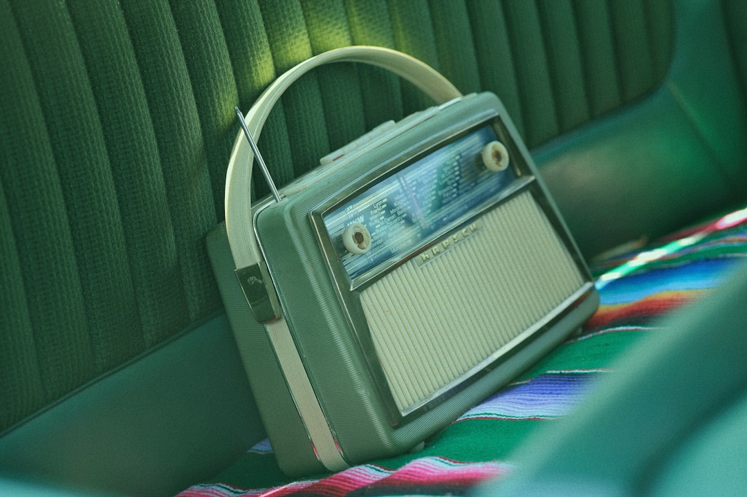 gray cassette radio, It is small and it is beautiful. It sits there on back seat of the huge american car and it emits t