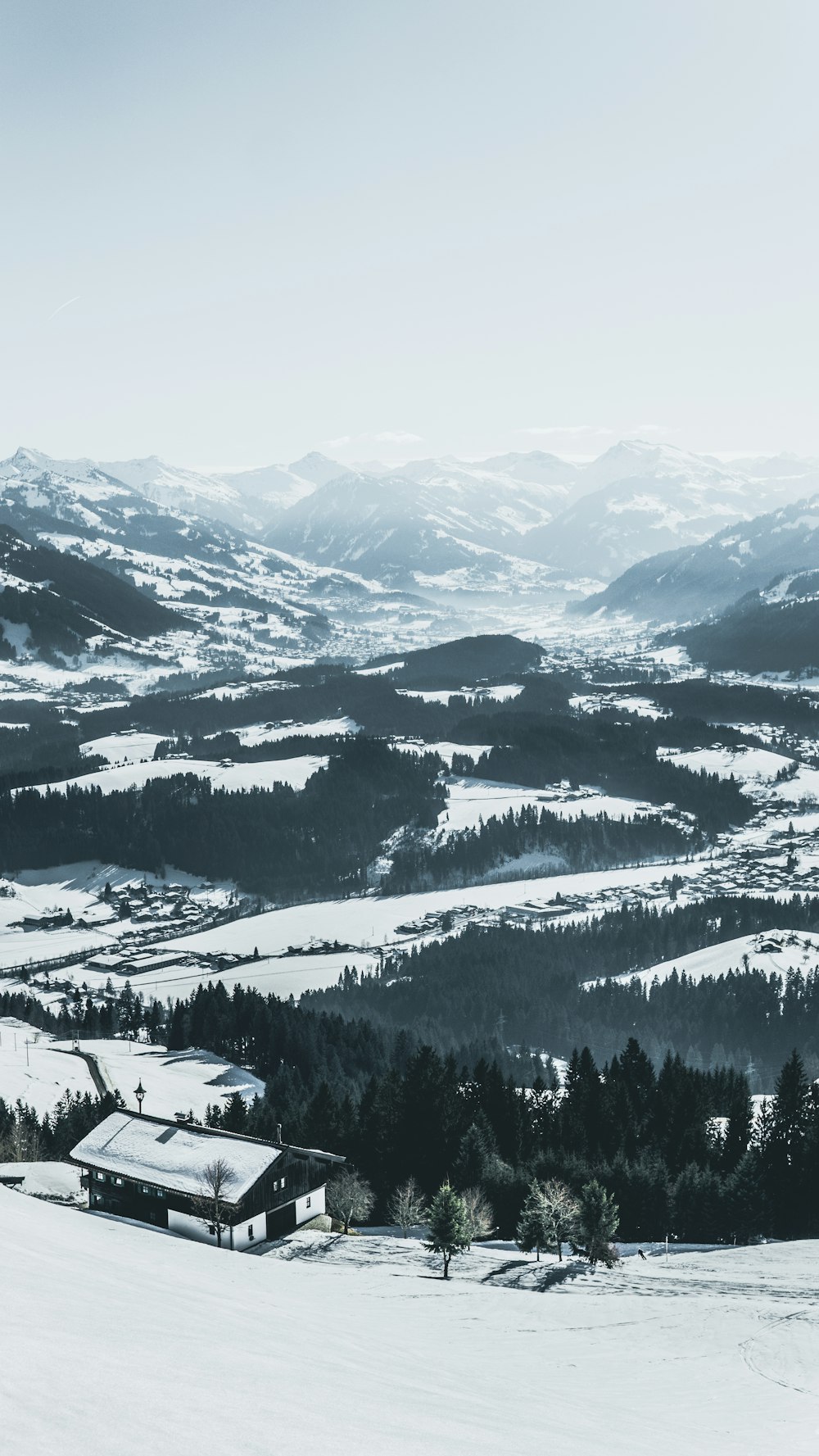 aerial photography of house rood and roads covered with snow at daytime