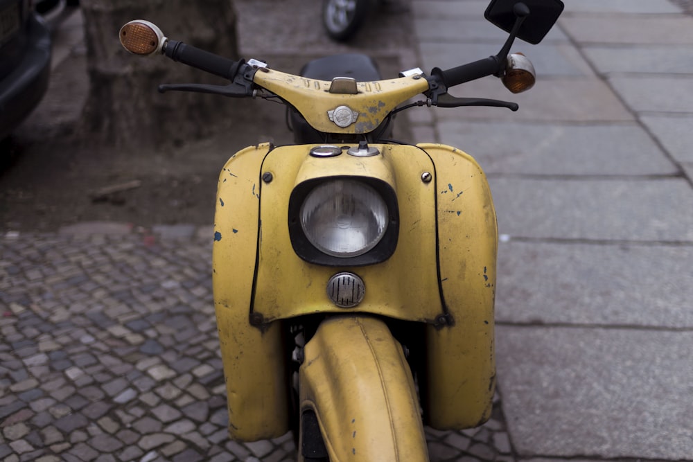 closeup photo of yellow motor scooter
