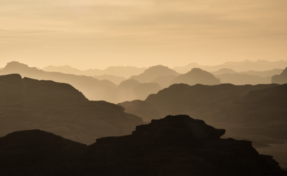 black and gray mountains under gray sky