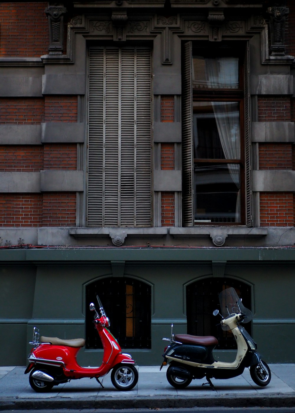 two motor scooters parked near building
