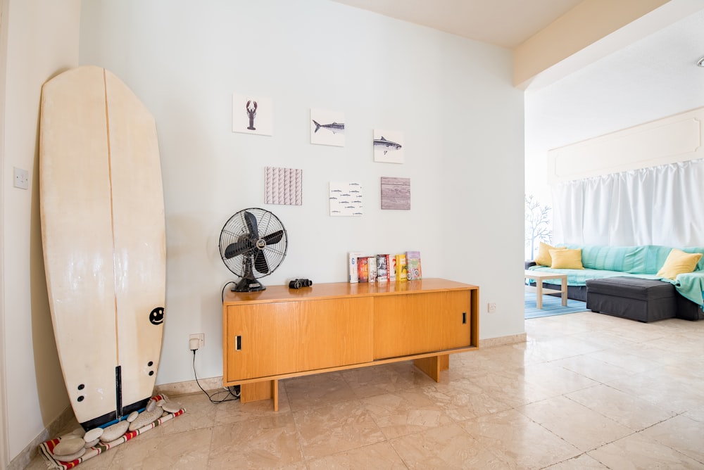 desk fan on credenza beside wall