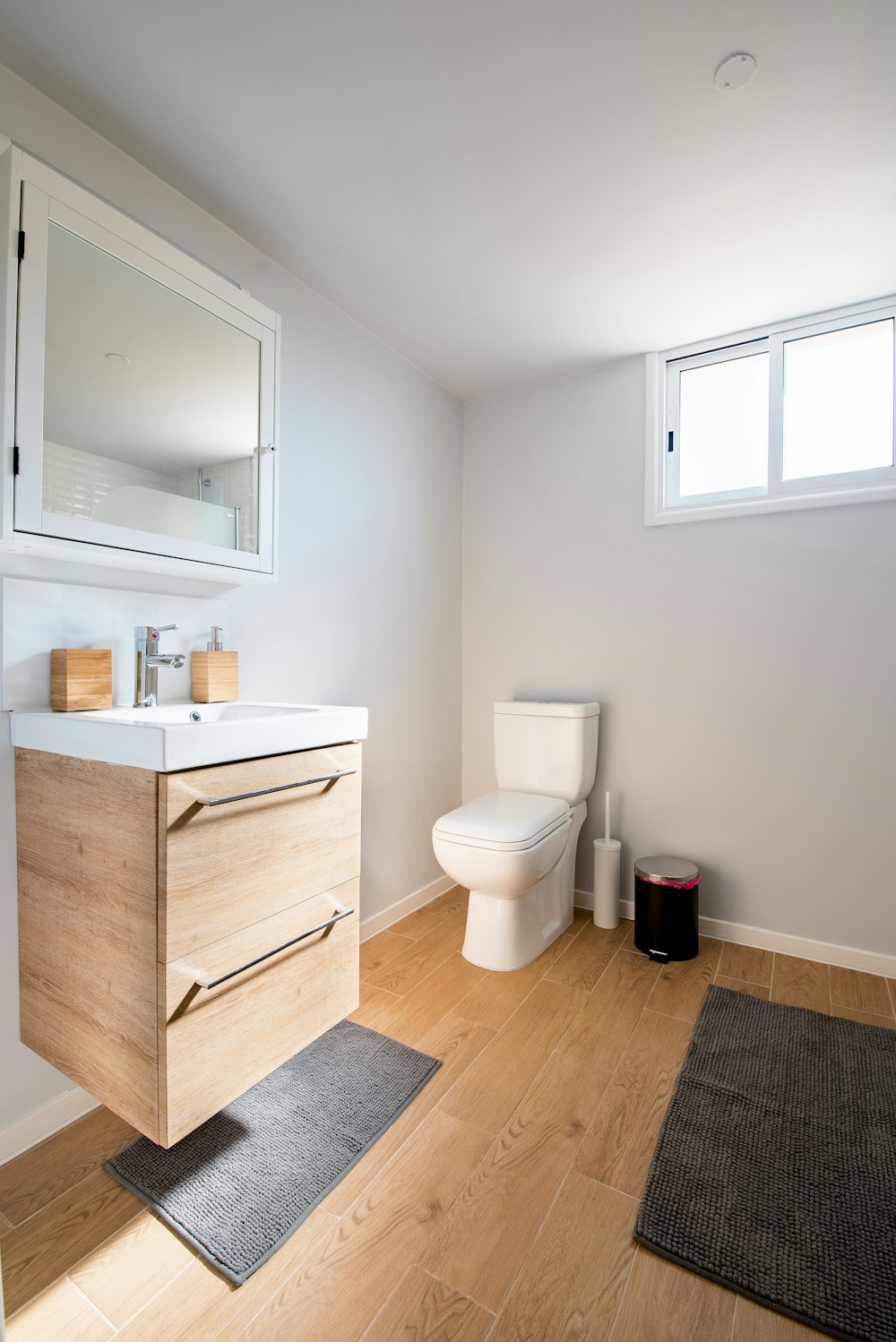 white ceramic toilet bowl near vanity combo