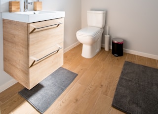 white ceramic toilet bowl near vanity combo