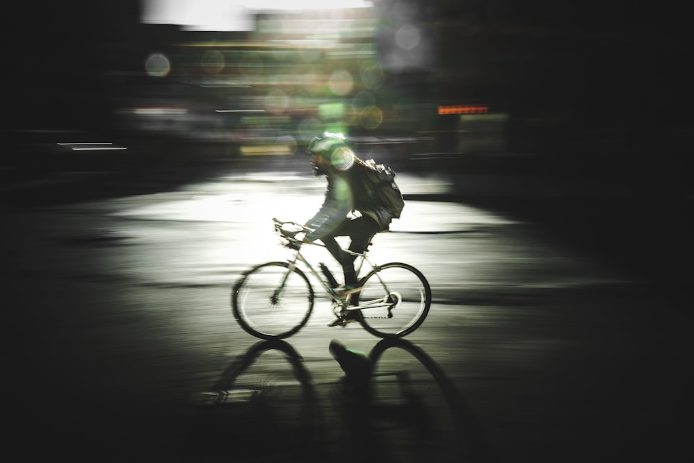 motion photography of man riding road bike