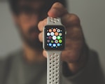 person holding silver aluminum case Apple Watch