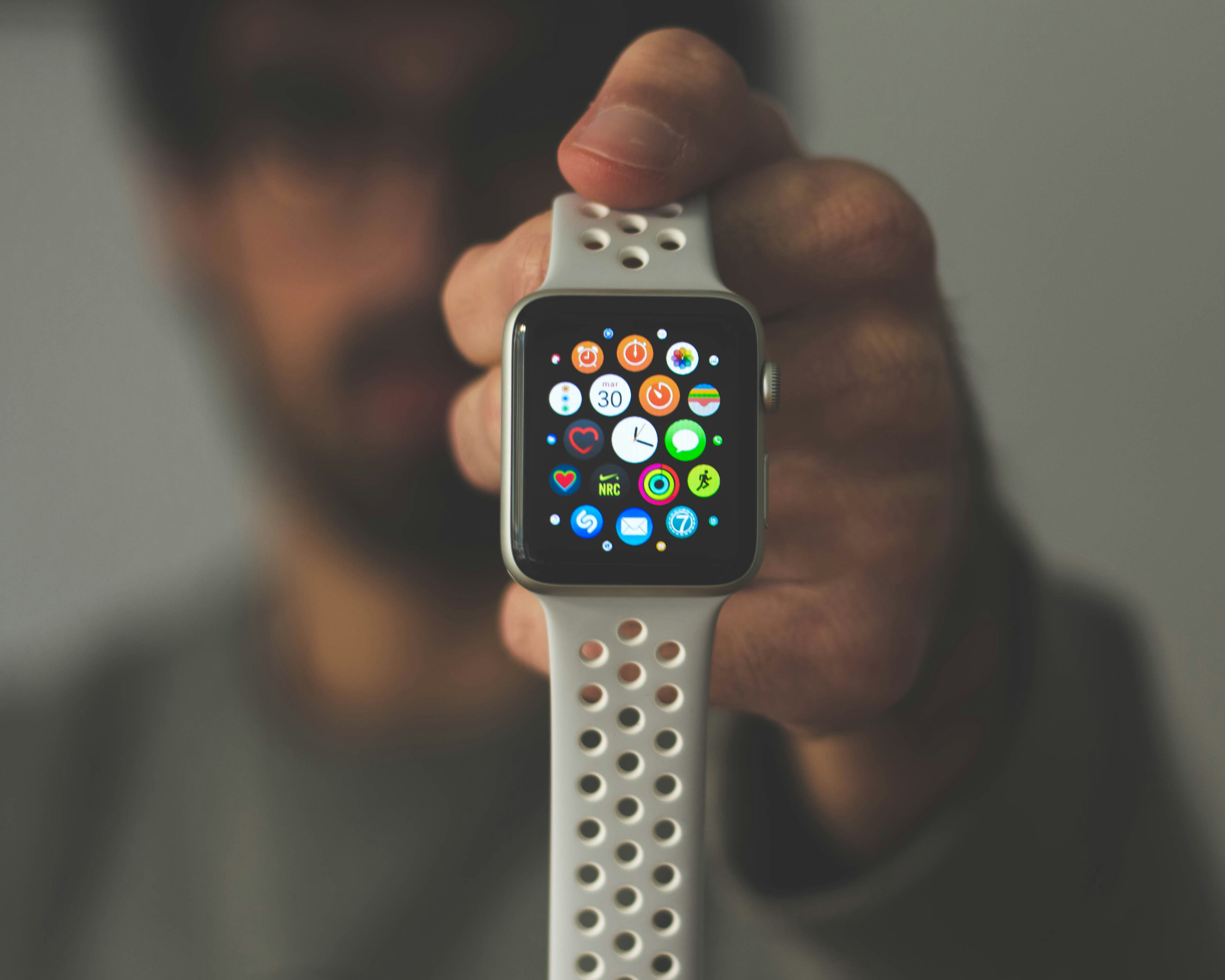 person holding silver aluminum case Apple Watch