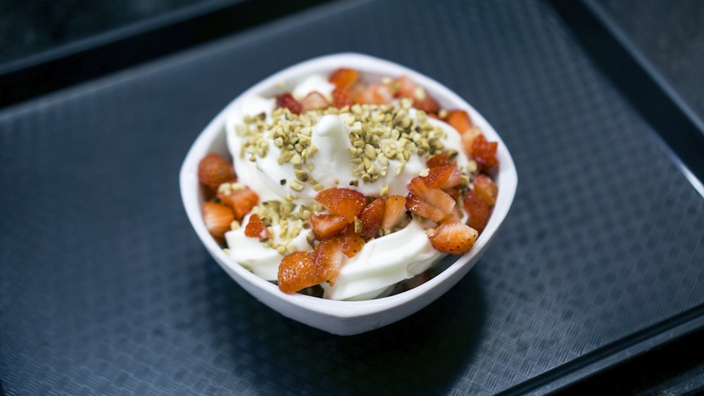 strawberry with cream on bowl