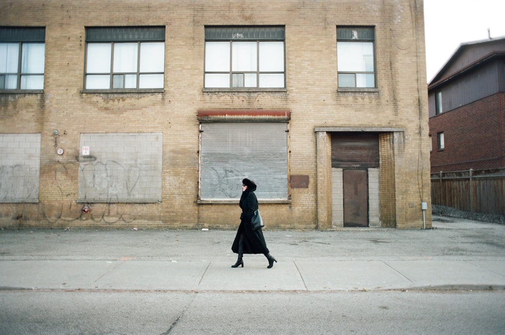 woman waking on gray pavement