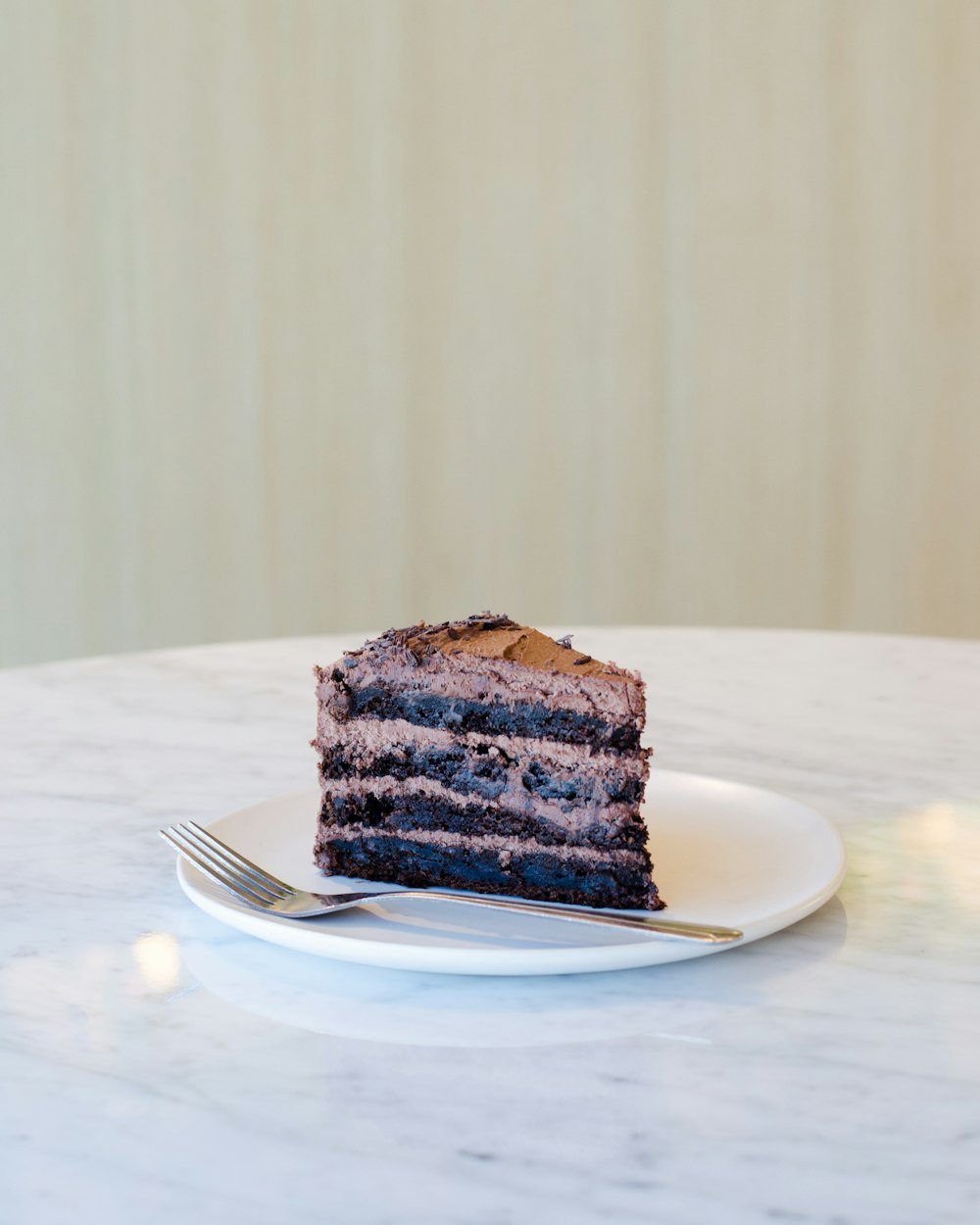 sliced chocolate cake beside fork on plate