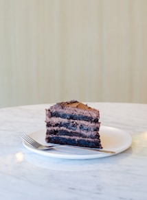 sliced chocolate cake beside fork on plate